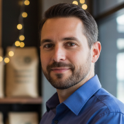 Close-up profile of a male small business owner, looking confidently forward.